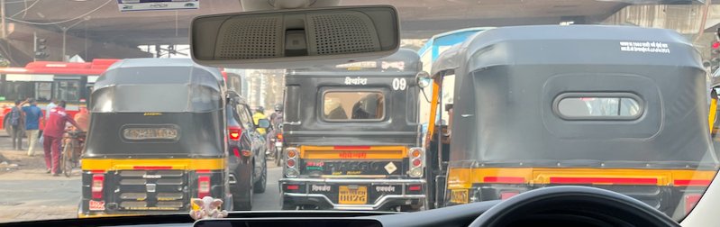 Autorickshaws sharing a busy street